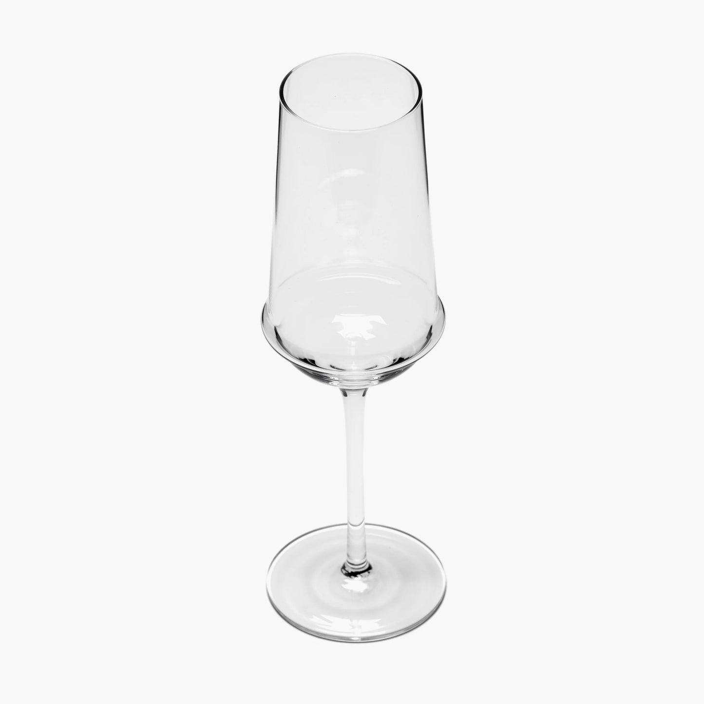 Clear glass champagne flute on a white background