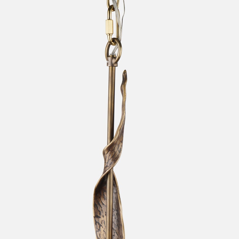 Gold pendant with a unique design on a white background