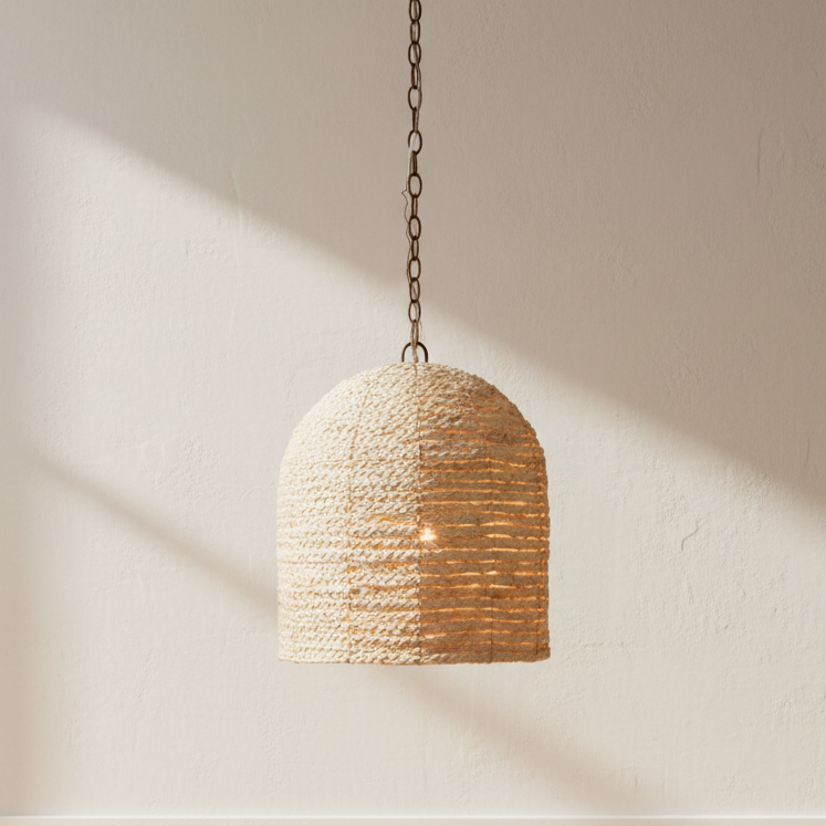 Woven pendant light hanging in a room with wooden floor and white walls