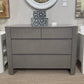 Gray dresser with decorative items in a room setting