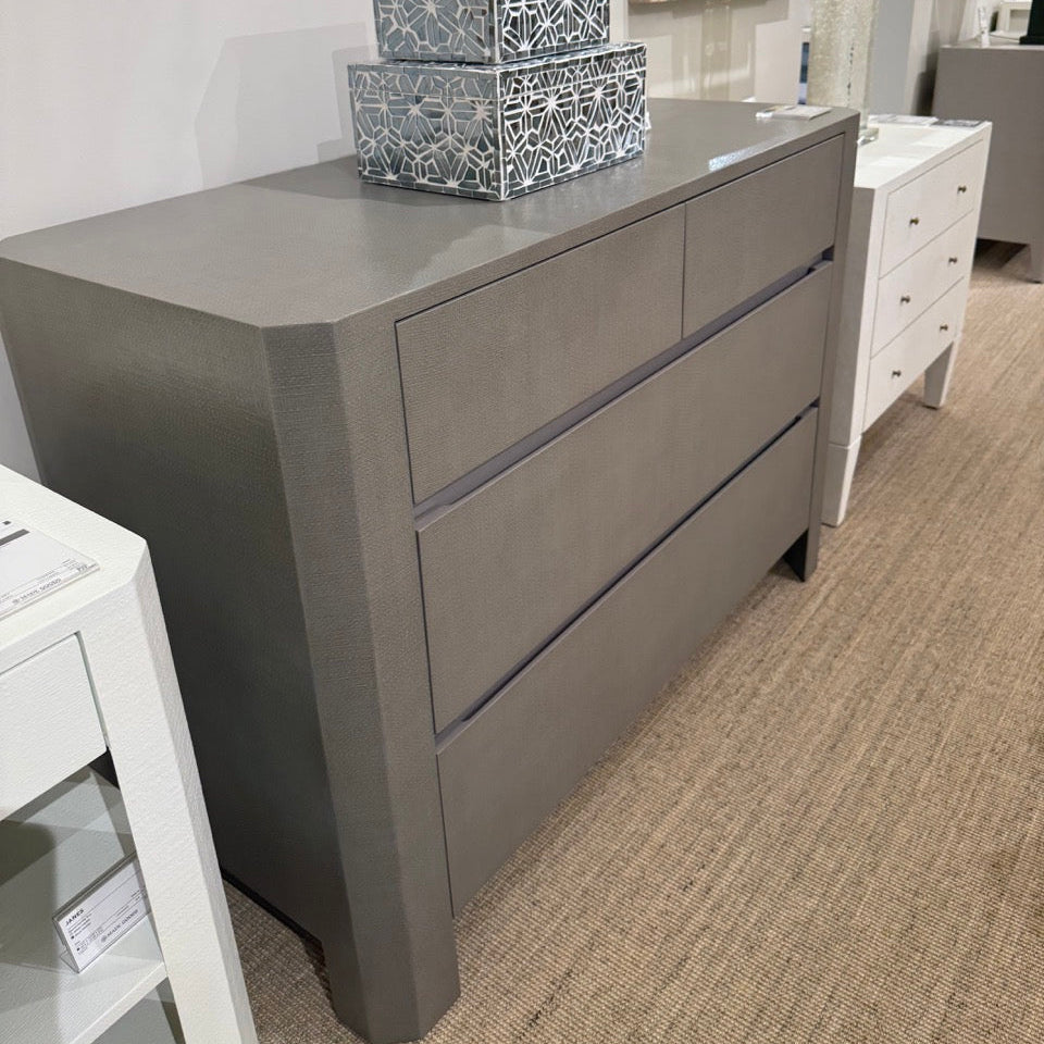 Gray dresser with decorative items in a room setting