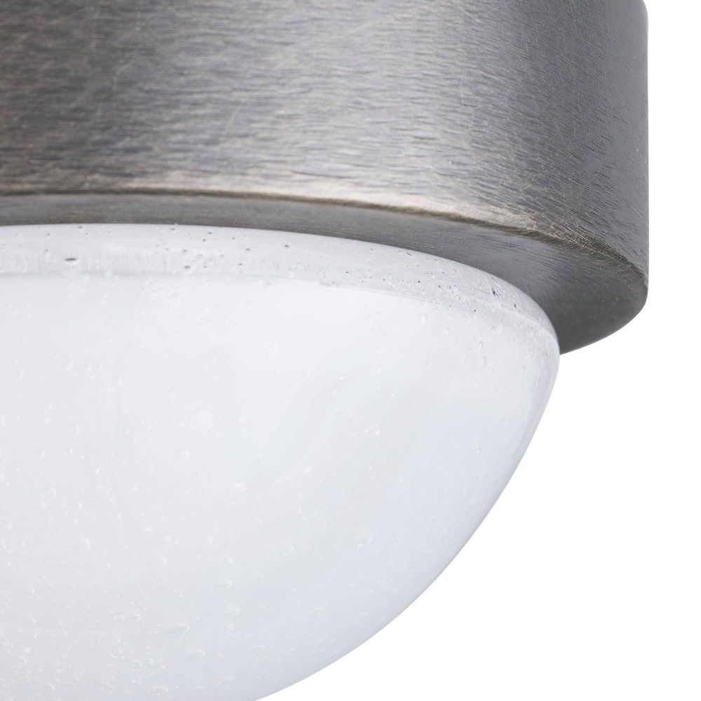 Close-up of a cylindrical concrete object with a textured metal top on a white background