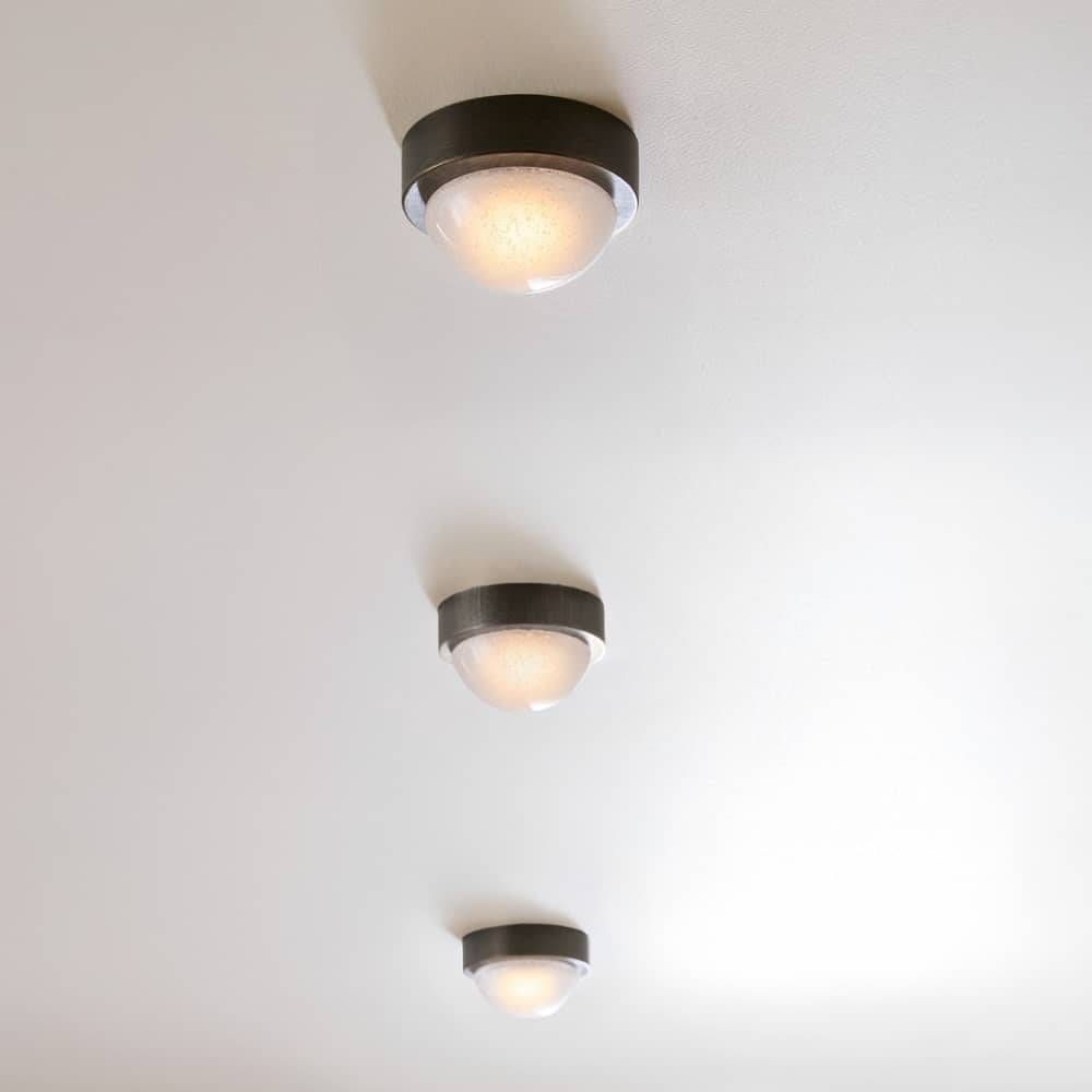 Three ceiling lights on a white ceiling