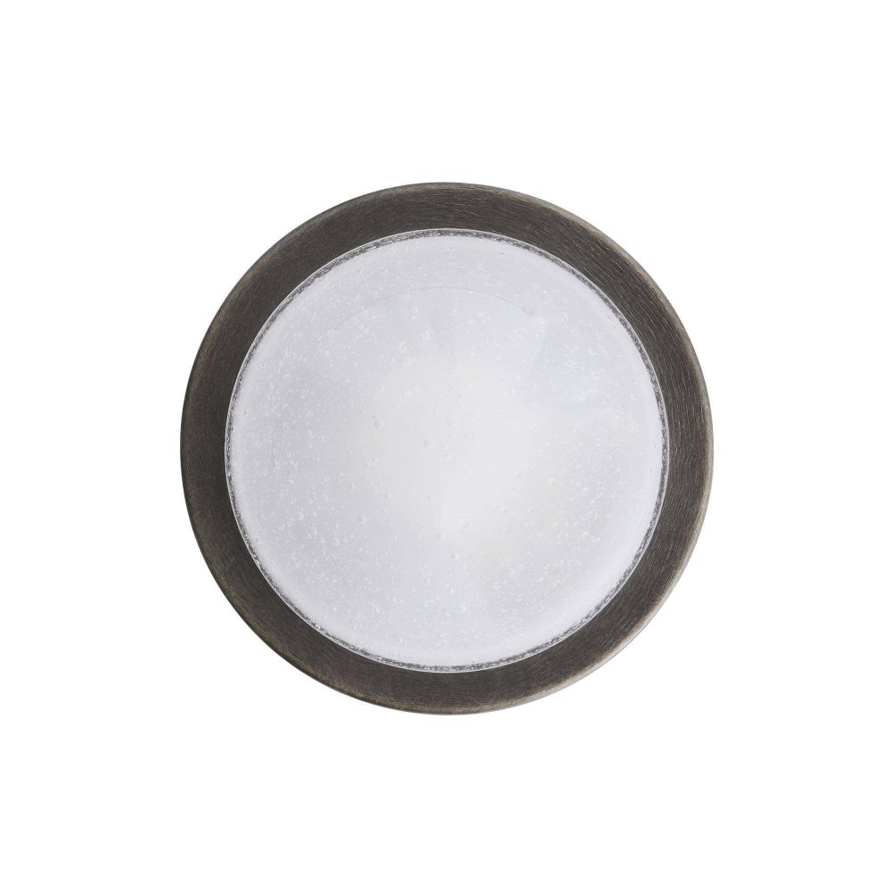 Round metallic object with a white center on a white background