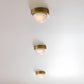 Three gold ceiling lights on a white ceiling