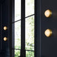 Modern wall lights on a dark wall with a window in the background