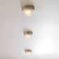 Three ceiling lights on a white ceiling
