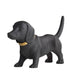 Black dog figurine with a gold collar on a white background