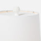 White lampshade with a small decorative item on a white background