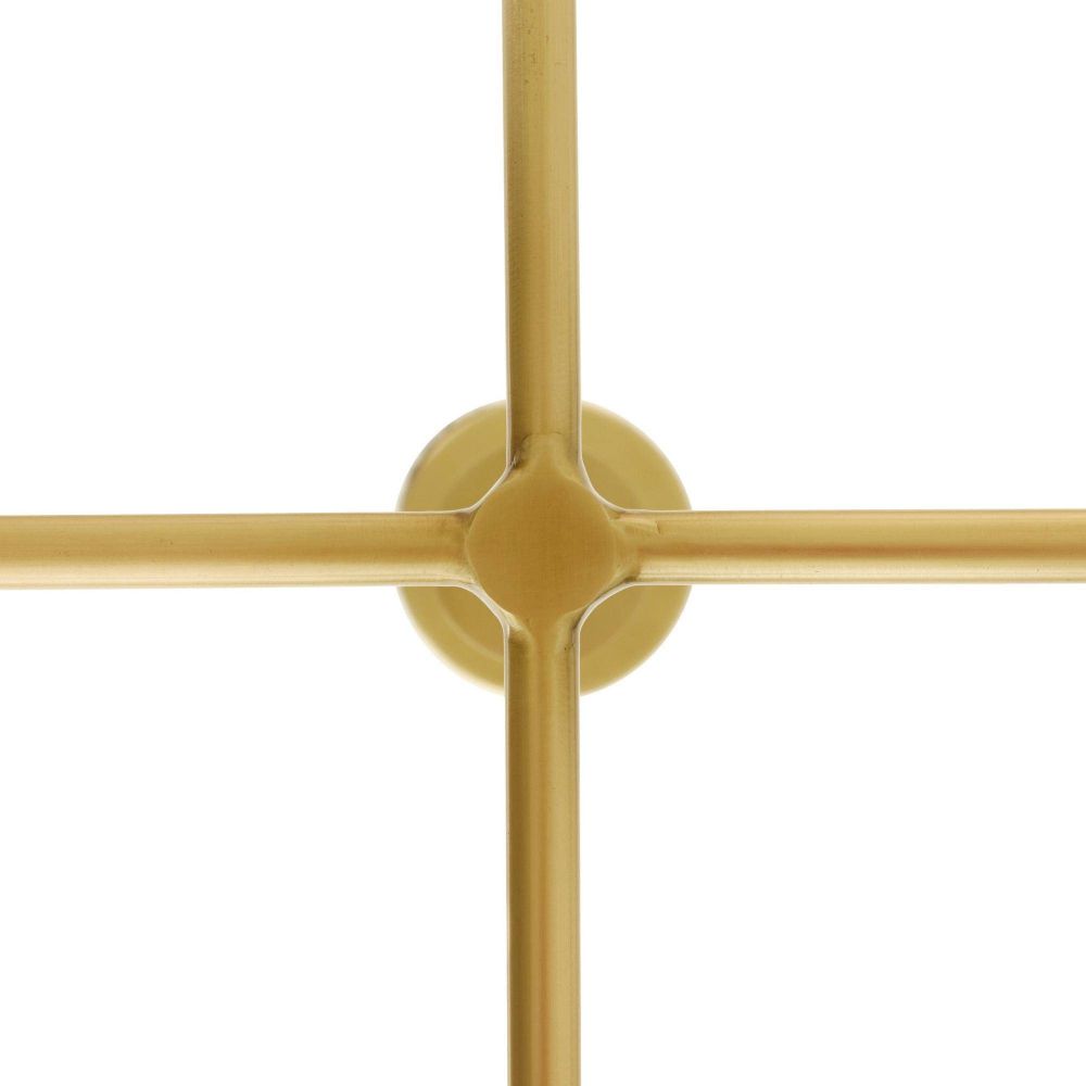 Gold decorative wall piece with intersecting bars on a white background