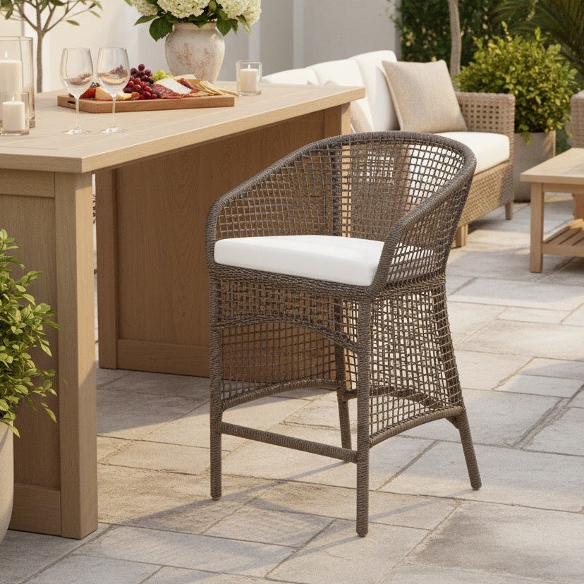 Outdoor patio setting with wooden table, wicker chairs, and decorative elements.