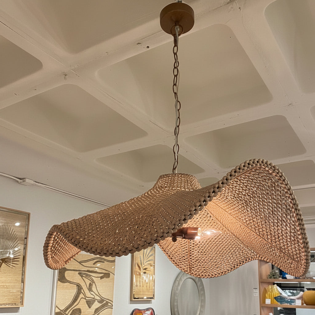 Woven chandelier hanging in a room with furniture and decor