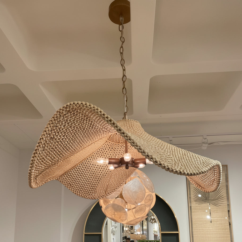 Woven pendant light hanging from a ceiling in a room with mirrors and lights.