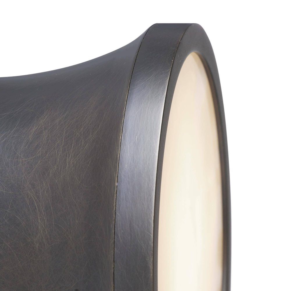 Close-up of a cylindrical wall light fixture with a dark bronze finish.