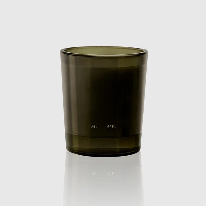 Dark green glass candle holder on a white background