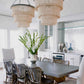 Modern kitchen with pendant lights, dining table, and chairs.