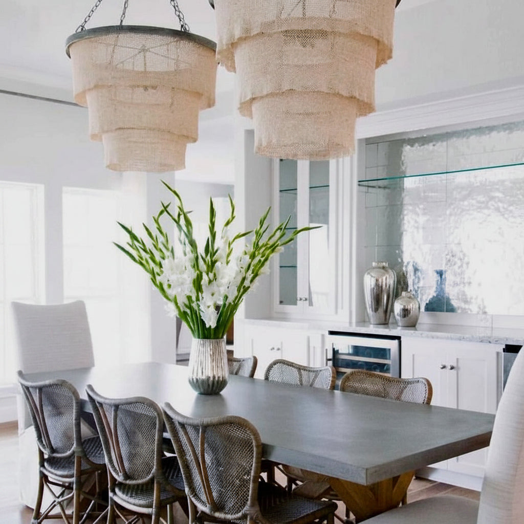 Modern kitchen with pendant lights, dining table, and chairs.