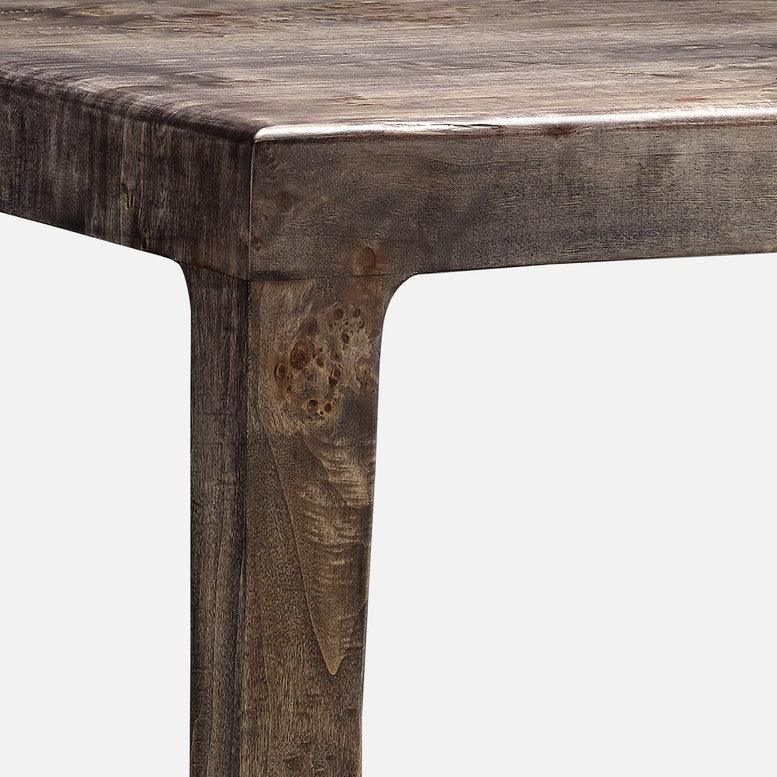 Close-up of a wooden table corner with a white background