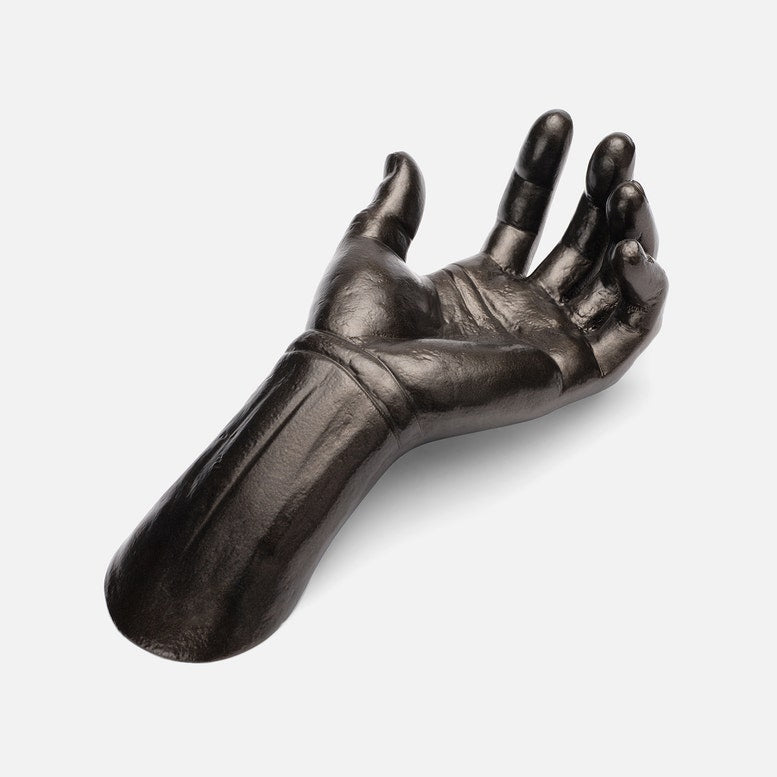 Metallic hand sculpture on a white background