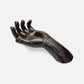 Black metal hand sculpture on a white background