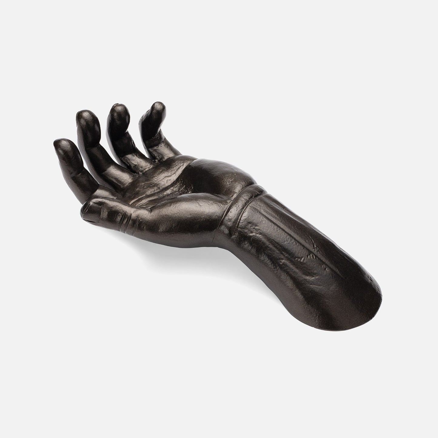 Black metal hand sculpture on a white background