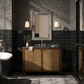 Bathroom with dark tiled walls, wooden vanity, and decorative elements.