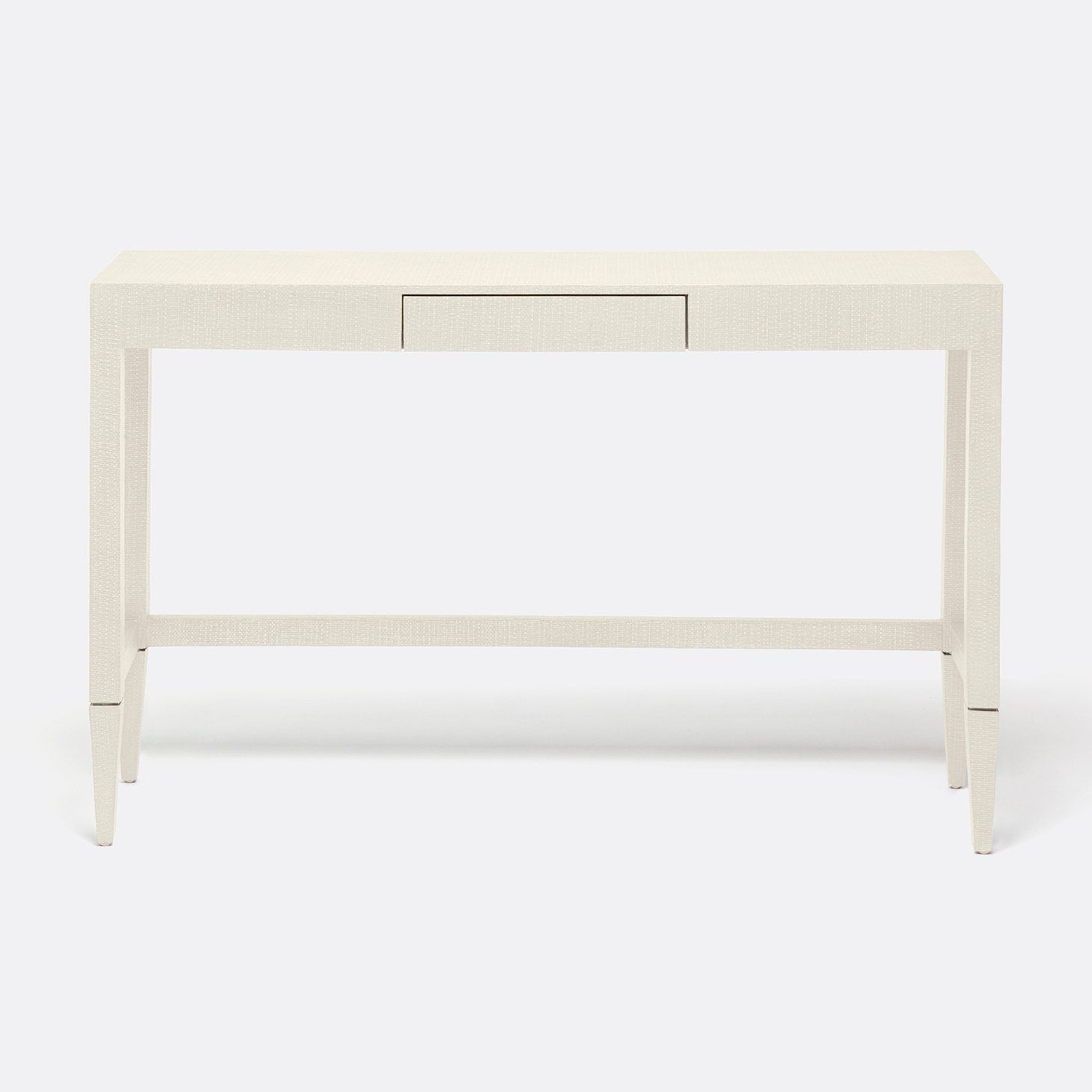 A modern console table with a light beige textured finish, featuring a single drawer, tapered legs, and a lower support rail, shown against a plain white background.