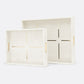 Two cream-colored trays with gold accents on a white background