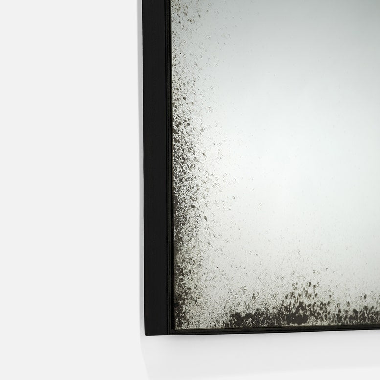Close-up of a textured black frame corner on a white background