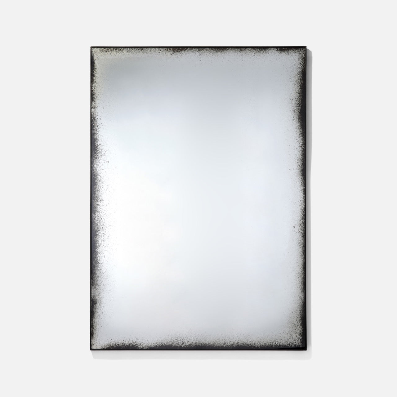Rectangular mirror with a textured black frame on a white background