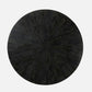 Black round table with a textured surface on a white background
