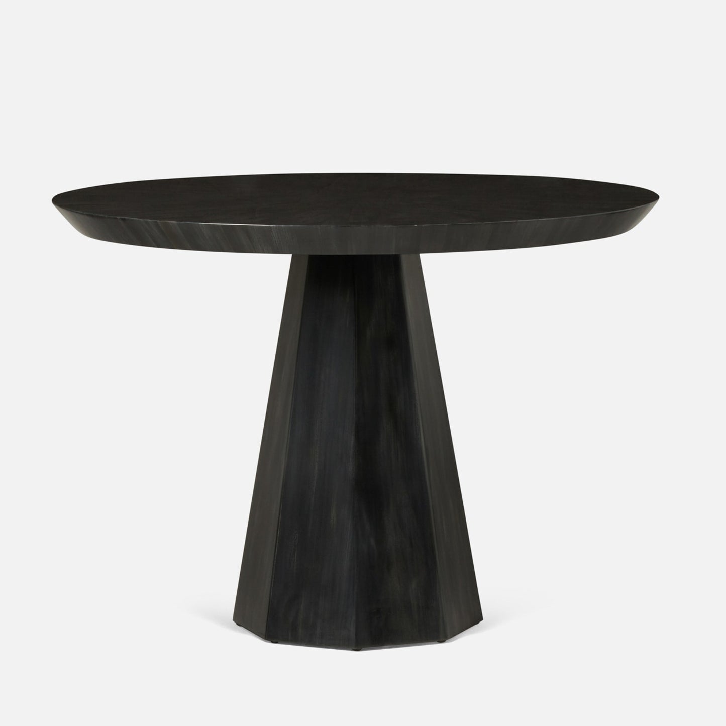 Black round dining table with a unique base design on a white background