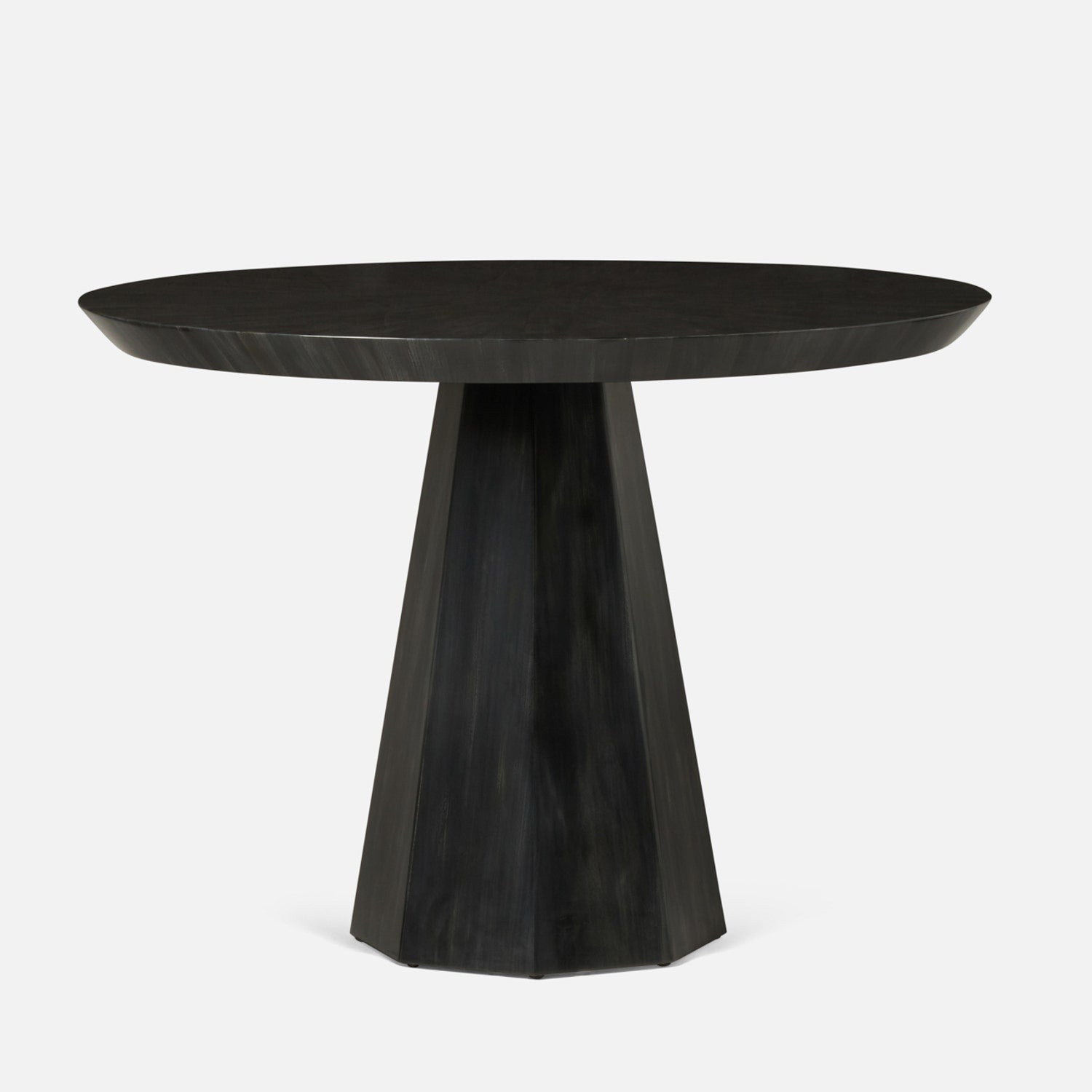 Black round dining table with a unique base design on a white background