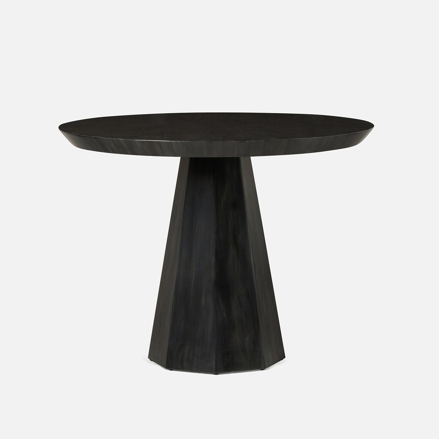 Black round table with a unique base design on a white background