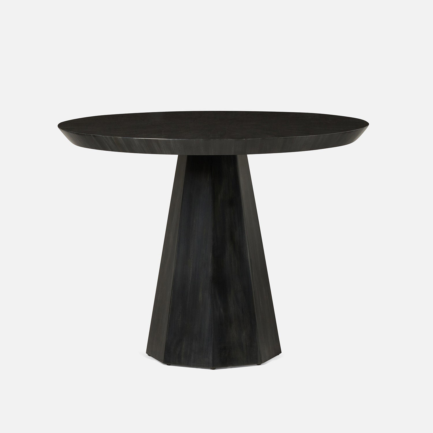 Black round table with a unique base design on a white background