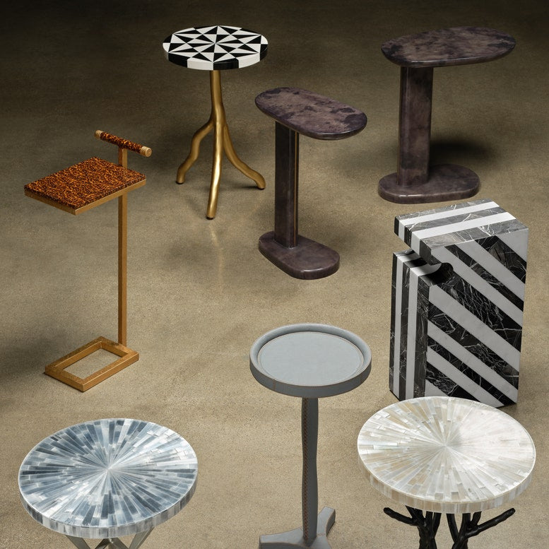 Collection of various small tables with different designs and materials on a brown background