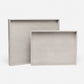 Two light gray trays on a white background