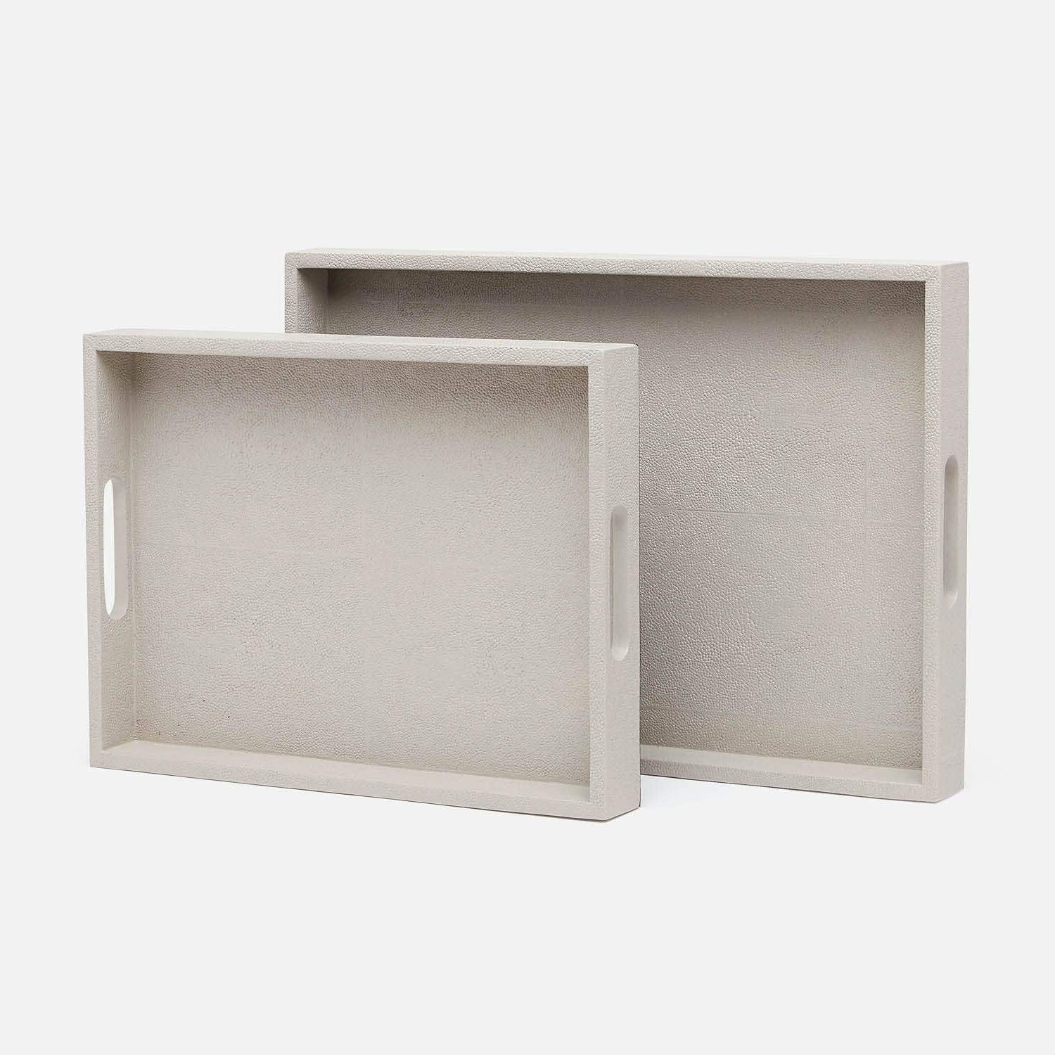 Two light gray trays with handles on a white background