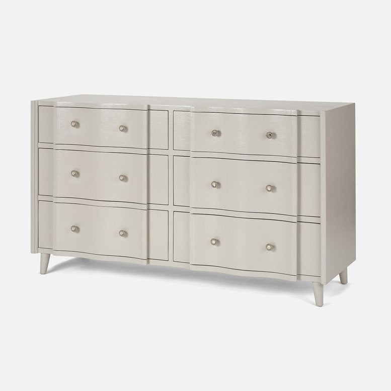 Light gray dresser with multiple drawers on a white background