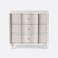 Light gray dresser with three drawers on a white background