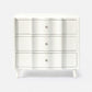 White dresser with three drawers on a white background