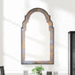 Decorative wall mirror with a decorative frame on a white wall.