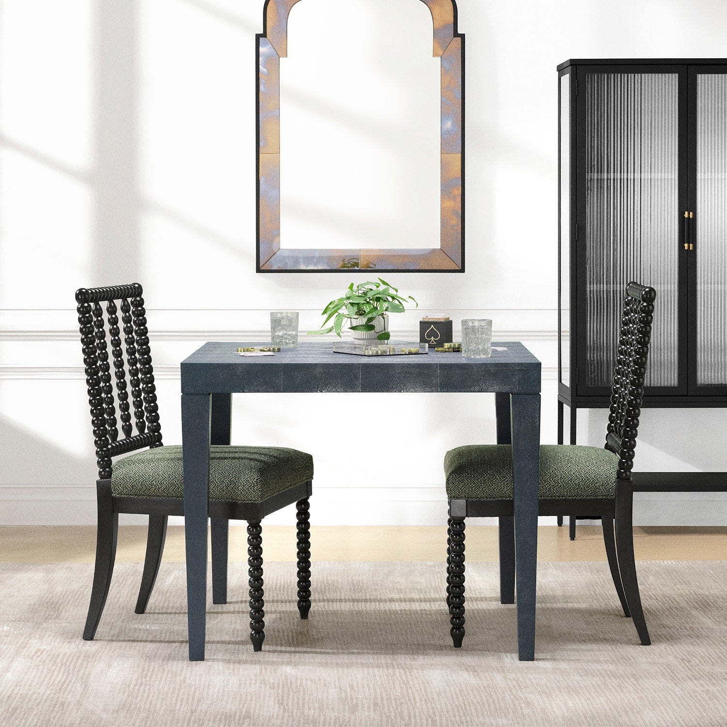 Dining table with two chairs in a room with a mirror and cabinet.
