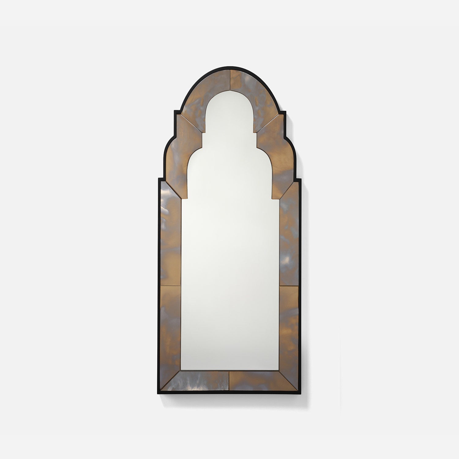 Decorative wall mirror with an arch-shaped frame on a white background