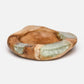 Wooden bowl with embedded green crystals on a white background
