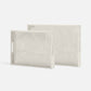 Two rectangular marble-patterned trays on a white background
