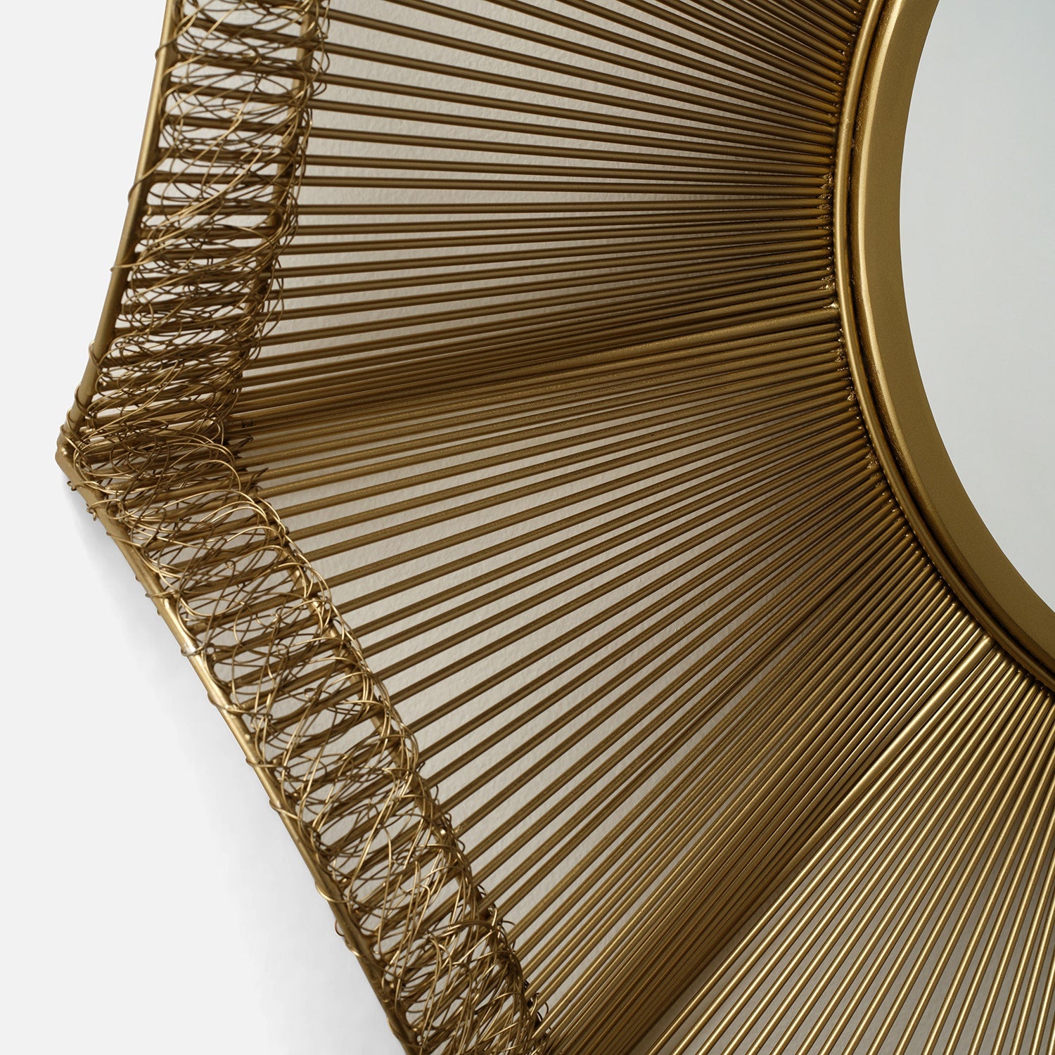 Close-up of a gold decorative wall mirror with intricate design