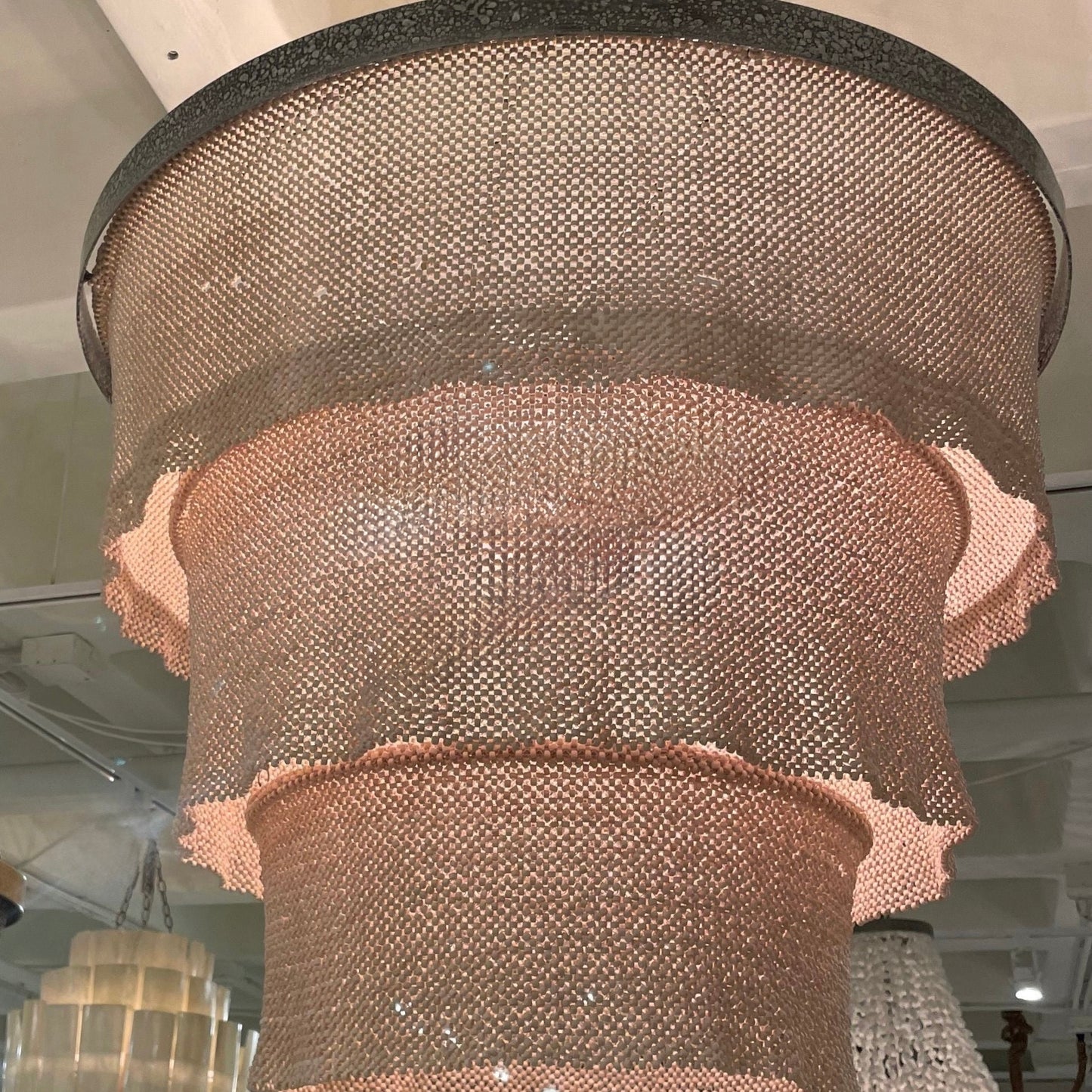 Decorative chandelier with mesh design hanging from the ceiling.