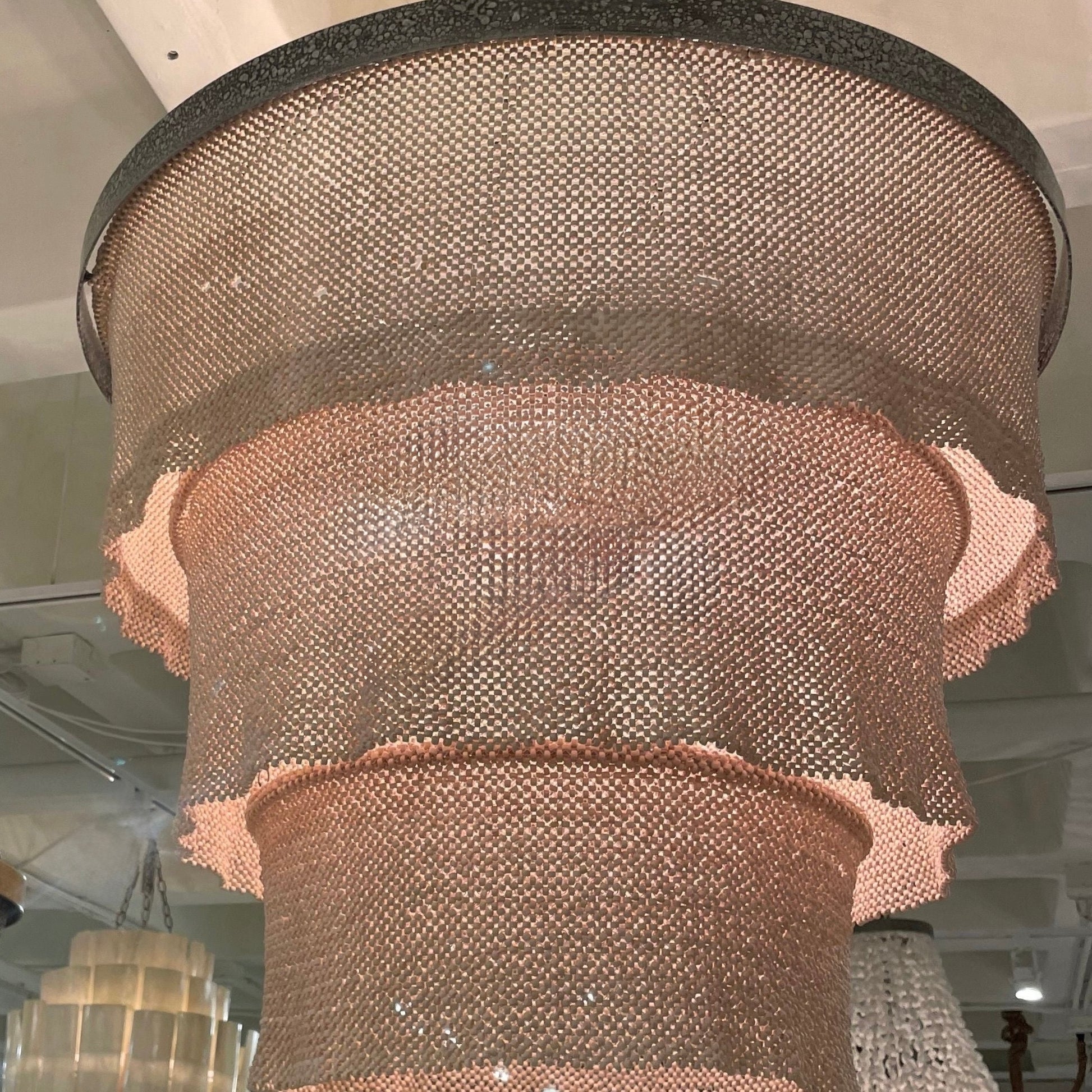 Decorative chandelier with mesh design hanging from the ceiling.