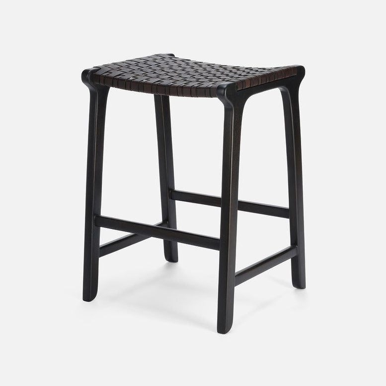 Black stool with woven seat on a white background